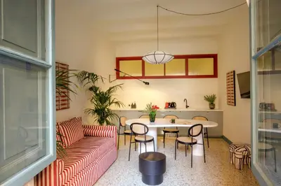 a living room with a couch and a table and chairs at Daplace - Serena Apartment in Rome