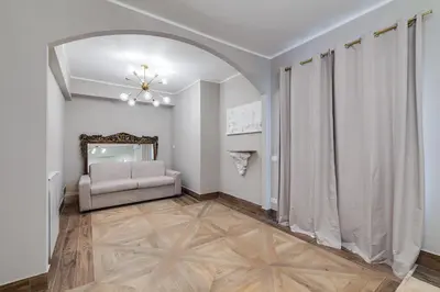 a living room with a couch and a chair at Vogue Suites Rome in Rome