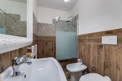 a bathroom with a sink and a toilet at Vogue Suites Rome in Rome