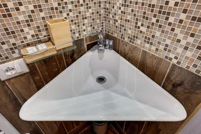 a white bath tub in a bathroom with tiles at Vogue Suites Rome in Rome