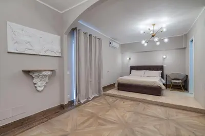 a bedroom with a bed and a fireplace at Vogue Suites Rome in Rome