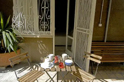 a table and chairs sitting outside of a building at B&B Tiburtina Garden in Rome