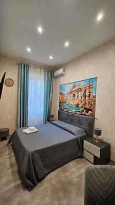 a bedroom with a bed and a painting on the wall at Casa Camillo in Rome