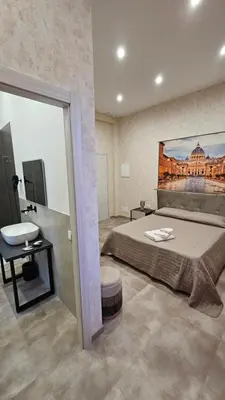 a bedroom with a bed with a painting on the wall at Casa Camillo in Rome