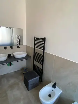 a bathroom with a white toilet and a sink at Casa Camillo in Rome
