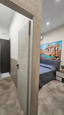 a bedroom with a bed with a painting on the wall at Casa Camillo in Rome