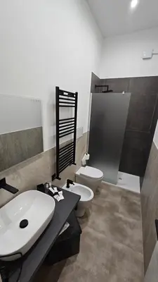 a bathroom with a white sink and a toilet at Casa Camillo in Rome