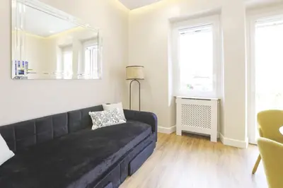 a living room with a couch and a mirror at Easylife - Charme, comfort e quiete vicino Termini in Rome
