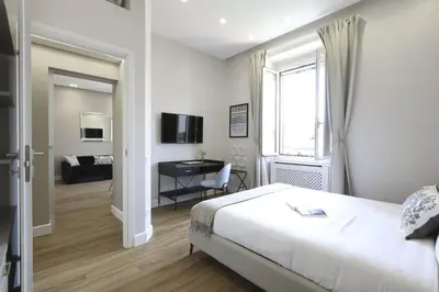 a bedroom with a bed and a desk and a window at Easylife - Charme, comfort e quiete vicino Termini in Rome