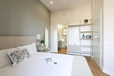 a bedroom with a white bed and a bathroom at Easylife - Charme, comfort e quiete vicino Termini in Rome