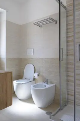 a bathroom with a toilet and a sink and a shower at Luxury Domus- Metro Malatesta in Rome