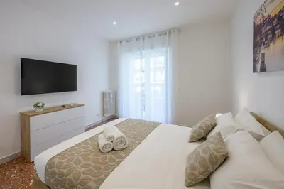 a bedroom with a large bed with a flat screen tv at Luxury Domus- Metro Malatesta in Rome