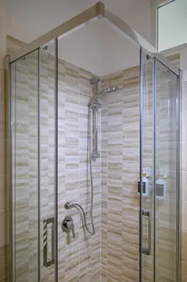 a shower with a glass enclosure in a bathroom at Luxury Domus- Metro Malatesta in Rome