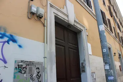 a door on the side of a building with graffiti at Rooms Piramide 1 in Rome