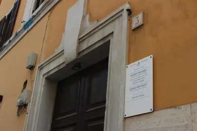 a door to a building with a sign on it at Rooms Piramide 1 in Rome