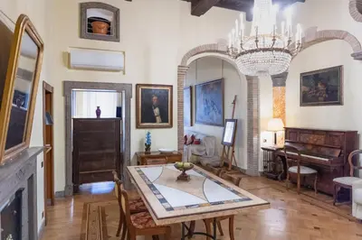 a living room with a table and a piano at Roman Charme Spagna in Rome