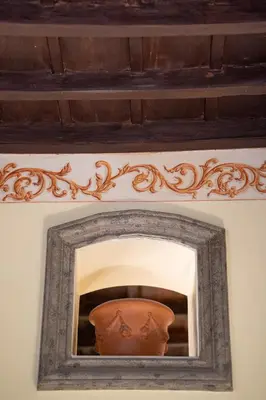 a vase in a frame on a wall at Roman Charme Spagna in Rome