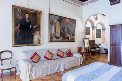 a living room with a couch and a painting on the wall at Roman Charme Spagna in Rome