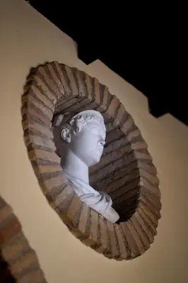 a statue of a bust of a woman on a wall at Roman Charme Spagna in Rome