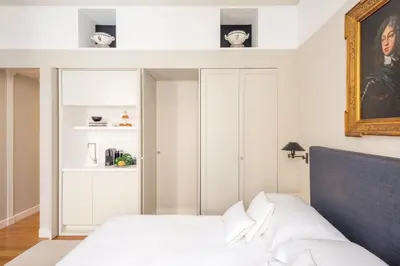 a bedroom with a bed and a painting on the wall at Crossing Condotti in Rome