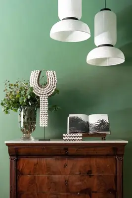 a wooden table with a vase of flowers and two lights at Crossing Condotti in Rome
