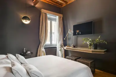 a bedroom with a white bed and a window at Crossing Condotti in Rome