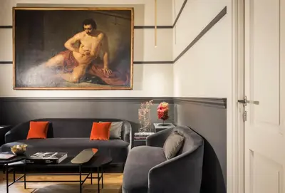 a living room with a painting of a man at Crossing Condotti in Rome