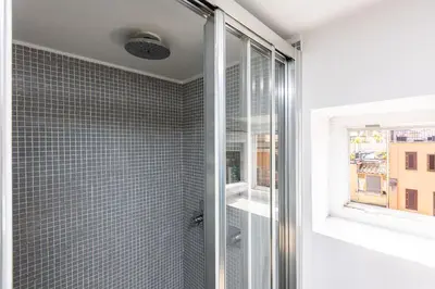 a bathroom with a shower and a window at Borgo Vittorio Terrace by Rental in Rome in Rome