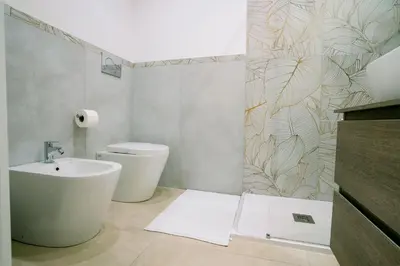 a bathroom with a sink and a toilet at 4 Seasons Roma Trastevere in Rome