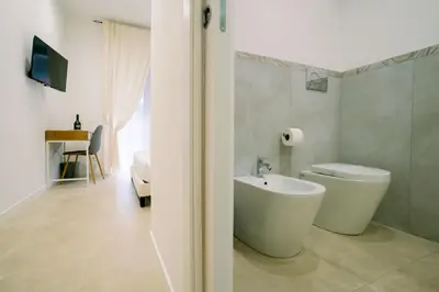 a bathroom with a white toilet and a sink at 4 Seasons Roma Trastevere in Rome