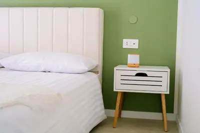 a bedroom with a white bed and a white nightstand at 4 Seasons Roma Trastevere in Rome
