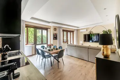 a kitchen and dining room with a table and chairs at ROMAN DREAM lll in Rome