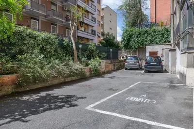 a parking lot with two cars parked on a street at ROMAN DREAM lll in Rome