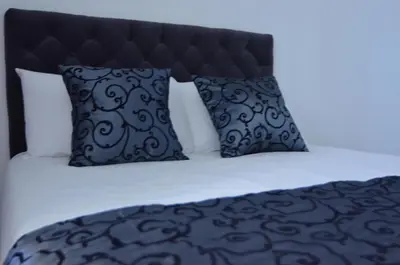 a bed with two pillows and a black and white bed at Rhome Lungotevere River in Rome