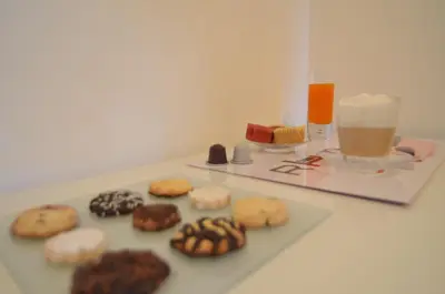 a table with cookies and a glass of orange juice at Rhome Lungotevere River in Rome