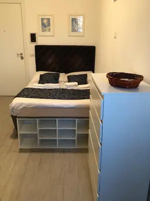 a bedroom with a large bed with a black headboard at Rhome Lungotevere River in Rome