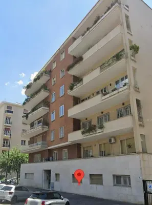 a red heart sign in front of a building at Rhome Lungotevere River in Rome