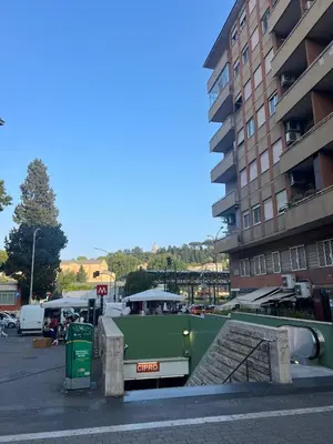 a green boat in a parking lot next to a building at F R Vatican view apartment in Rome