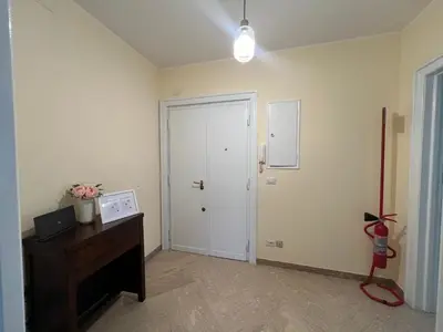 a room with a door and a desk with a lamp at F R Vatican view apartment in Rome