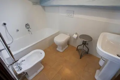 a bathroom with a tub and a toilet and a sink at Laurina F1 Studio with Panoramic Terrace - LOCAPPART in Rome