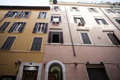 a tall building with windows and a clock on it at Laurina F1 Studio with Panoramic Terrace - LOCAPPART in Rome
