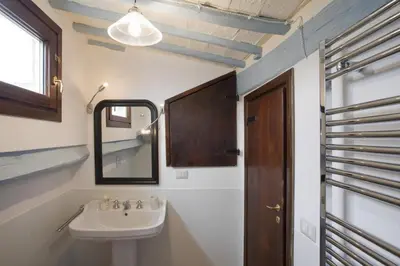 a bathroom with a sink and a mirror at Laurina F1 Studio with Panoramic Terrace - LOCAPPART in Rome