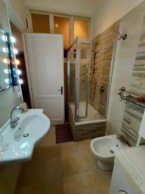 a bathroom with a sink and a shower and a toilet at Attico Luminoso Bed in Bormida in Rome