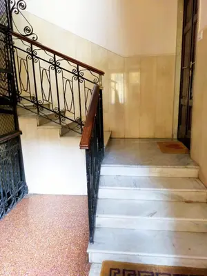 a staircase in a building with a wrought iron railing at Attico Luminoso Bed in Bormida in Rome