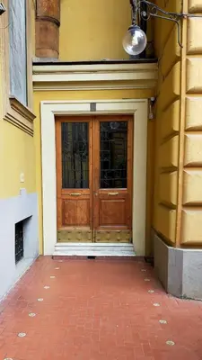 a wooden door on the side of a building at Attico Luminoso Bed in Bormida in Rome