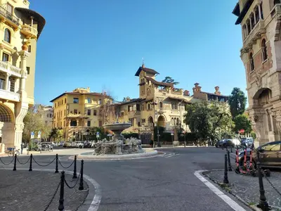 a city street with a fountain in front of buildings at Attico Luminoso Bed in Bormida in Rome