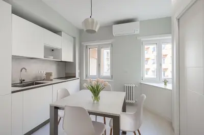 a kitchen and dining room with a table and chairs at Vatican Suites in Rome