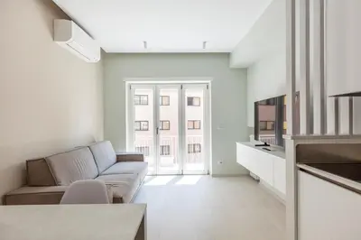 a living room with a couch and a tv at Vatican Suites in Rome