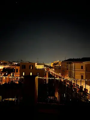 a view of a city at night with buildings at Vatican Rooftop Studio - NEW OPENING in Rome
