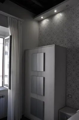 a bedroom with a white cabinet and a window at Imperial Relais in Rome